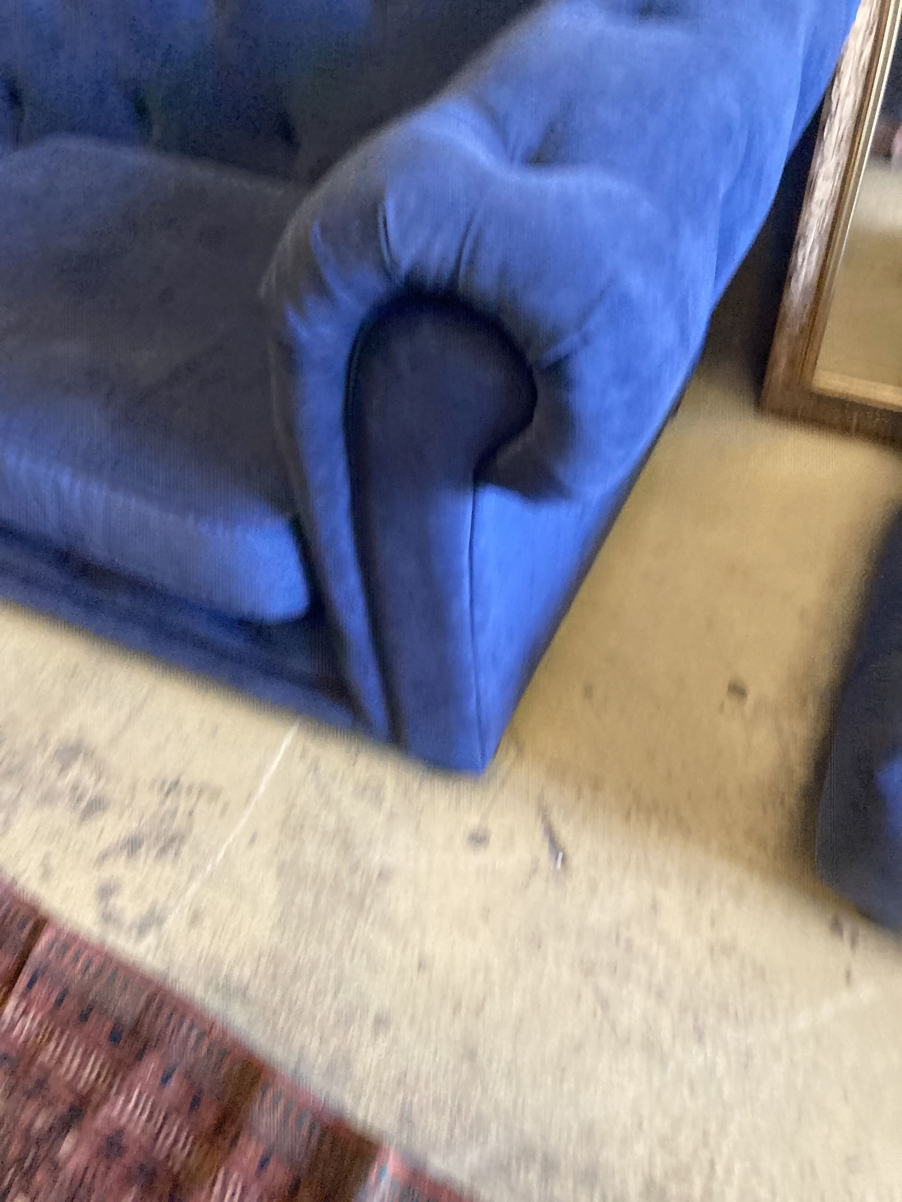 A pair of Chesterfield style settees upholstered in blue dralon and a footstool, largest length 210cm, depth 96cm, height 74cm